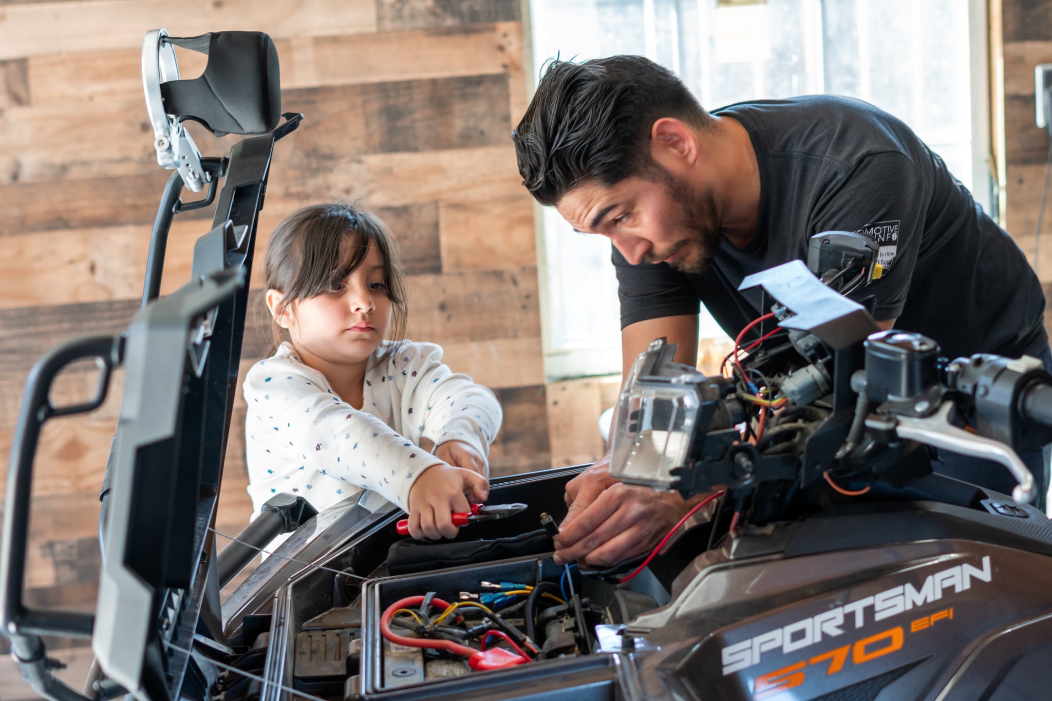 Mechanic working on a red sports car