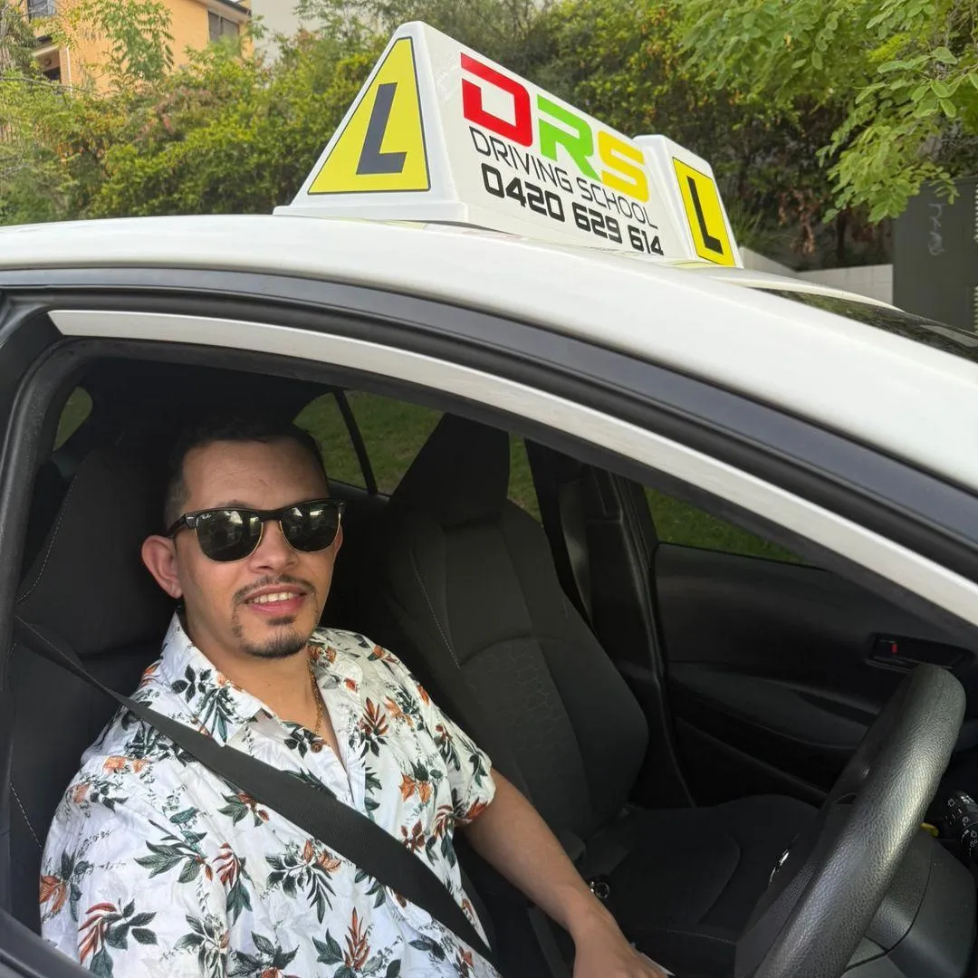 Dipak, friendly driving instructor in the car