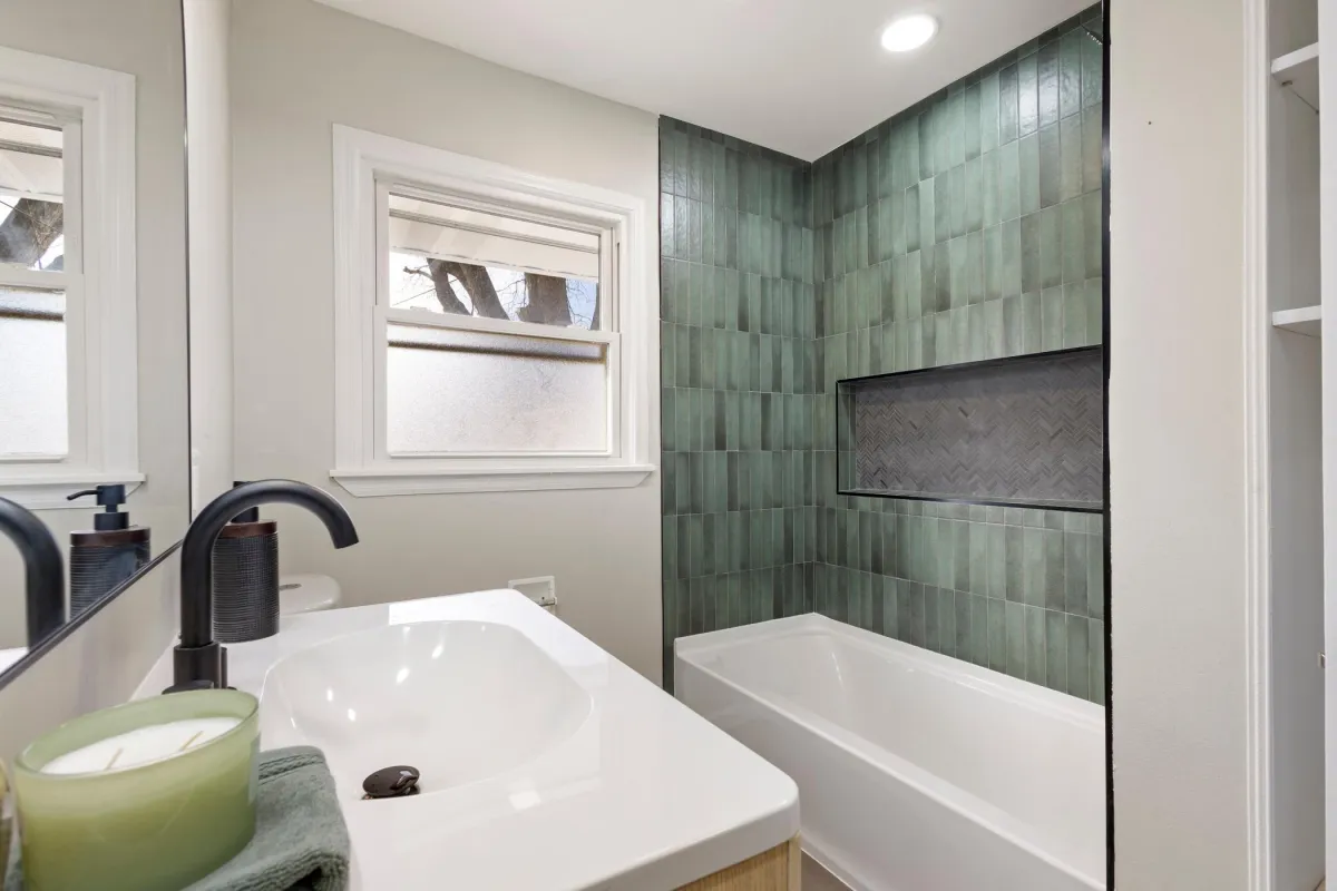 Modern walk-in shower with tile and rain head by Pro Partners Remodeling