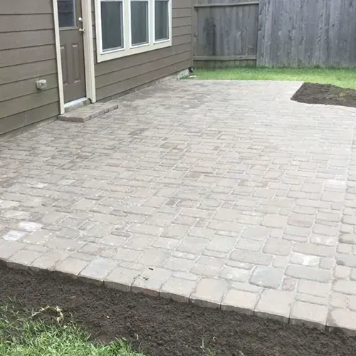 Paver patio installation with even surface and crisp edges.