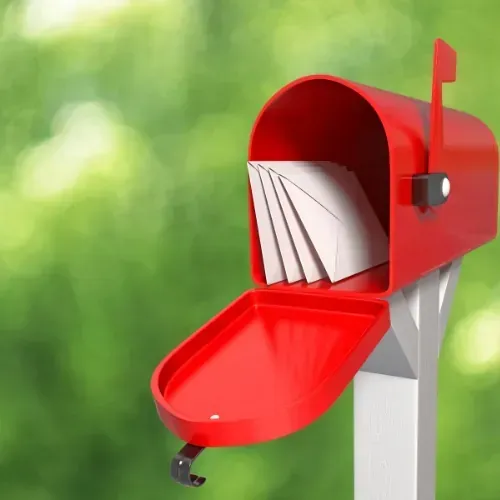 Red mailbox with mail illustrating professional mailbox installation.
