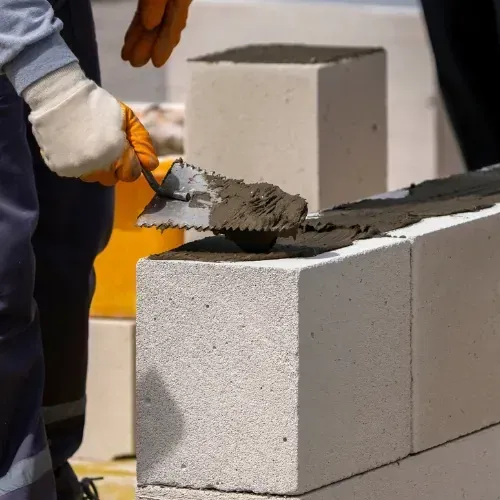 Concrete repair with trowel and block, M Z Masonry concrete services in Houston, TX.