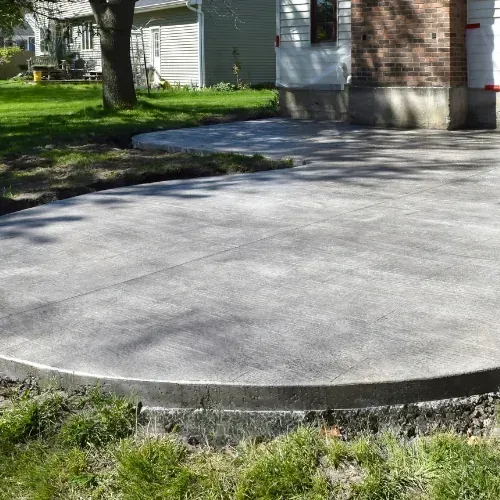 Newly poured concrete patio in Houston, TX with reinforced edges and control joints.