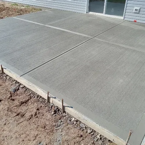 Newly poured concrete patio with control joints and proper base preparation in Sugar Land, TX.