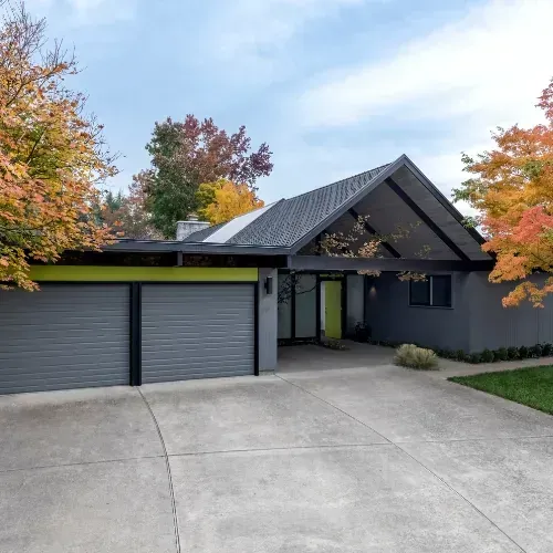Modern home with concrete driveway and garage in Sugar Land, TX