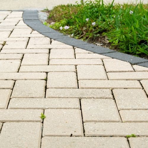 Interlocking paver design and brick paver installation in Sugar Land, TX backyard.