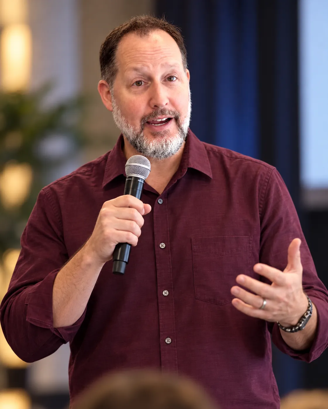 Kent Toussaint speaking passionately on stage at a family leadership conference