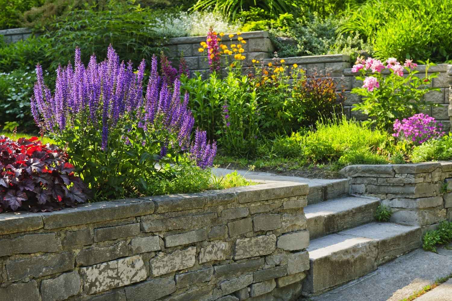 Flowers and plantings on top of a retaining wall