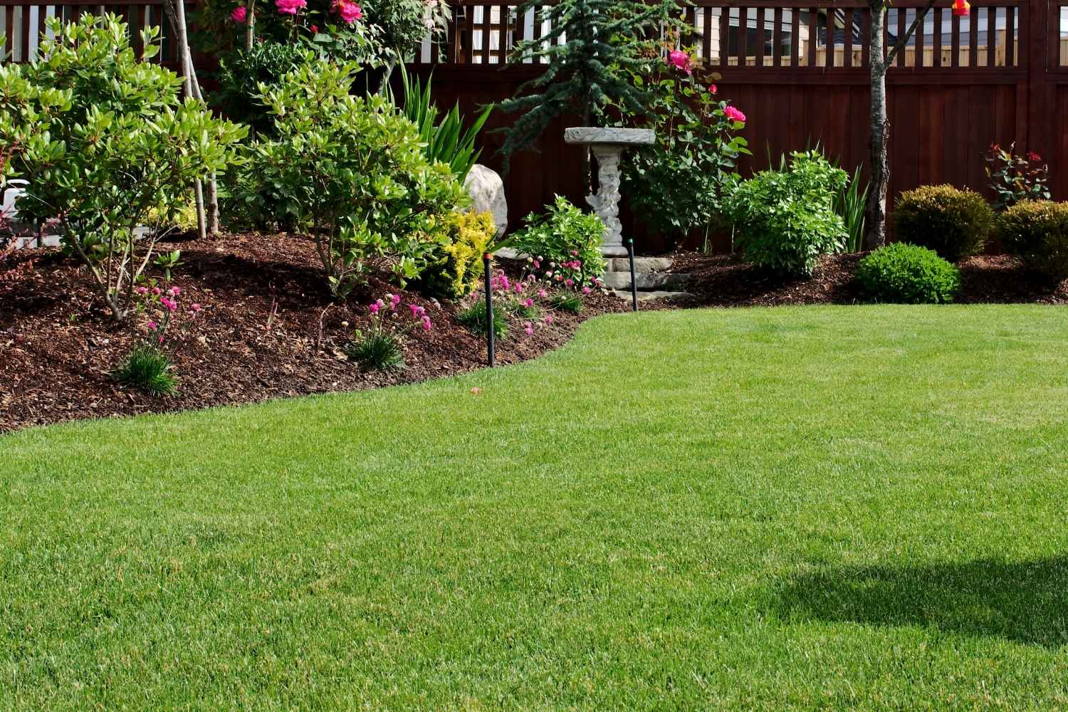 Healthy green grass with mulch installation in Lititz, PA