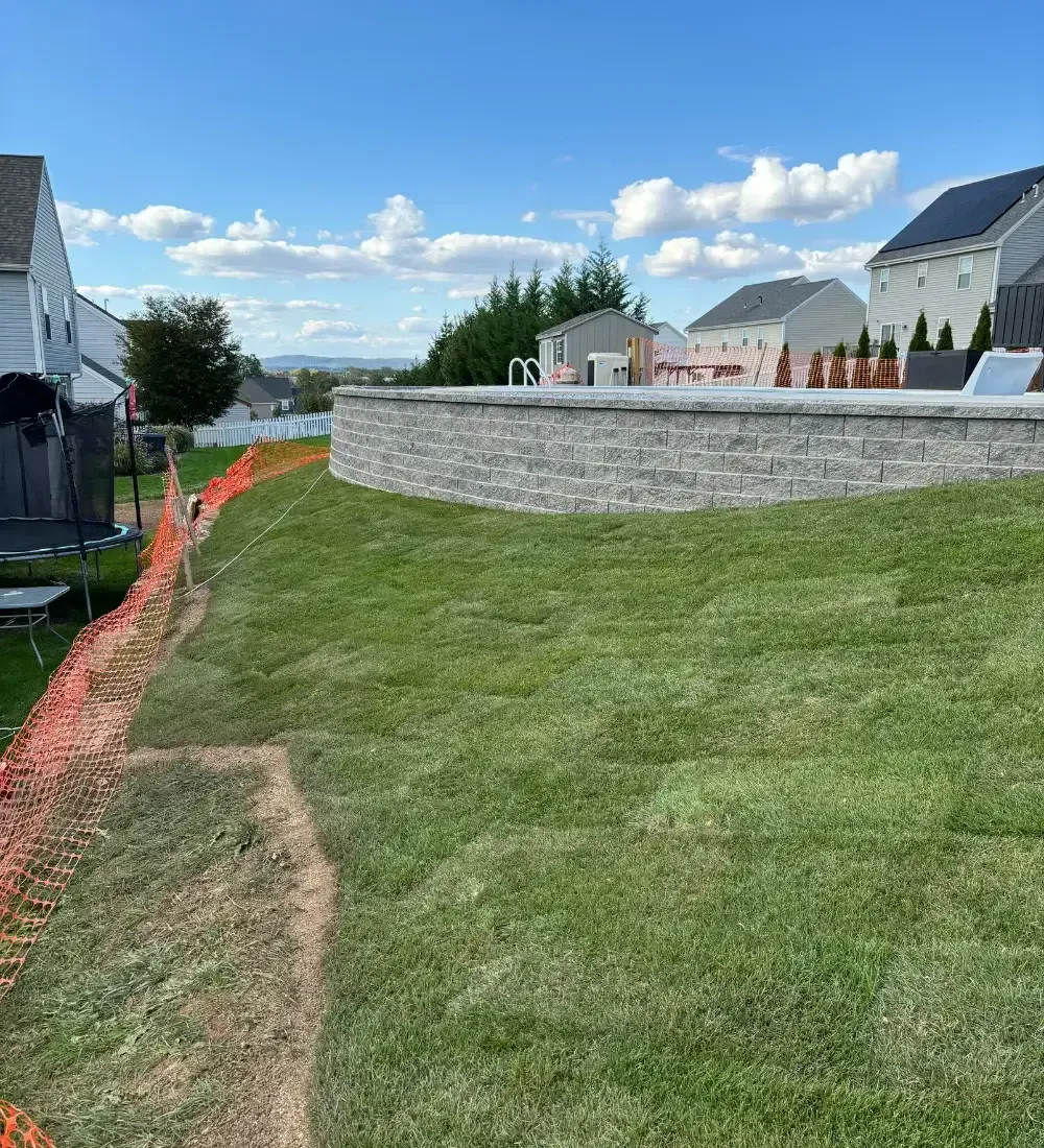 Green lawn in a concrete path and a square shrub with trees in Lititz, PA