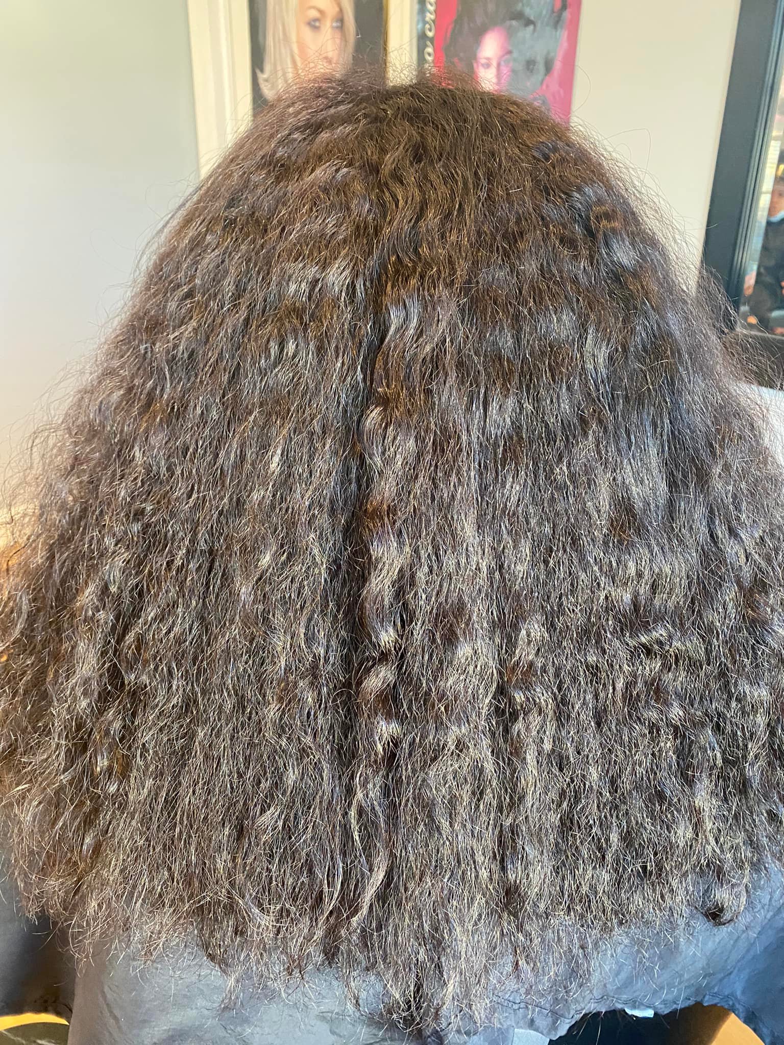 grayscale photography of woman getting her hair done inside salon