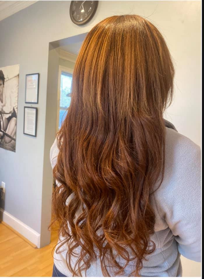 Young woman with long dark hair smiles