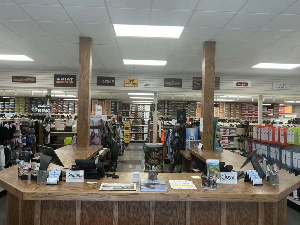 Inside Blue Mountain Shoes store showing organized shelves of boots and footwear in Shippensburg