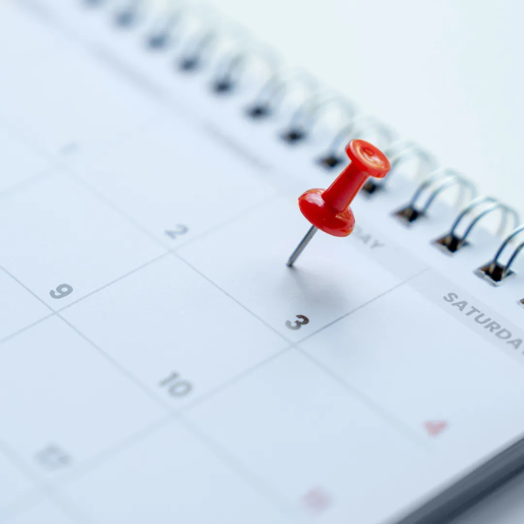 A Thumb tack on a calendar showing an appointment