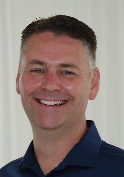 Portrait of Evan Harrington, financial professional, smiling, navy blazer, open-collar shirt, photorealistic, neutral background
