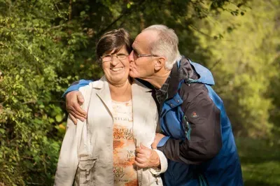 Agent and client discussing documents in a warm, trust-filled office setting