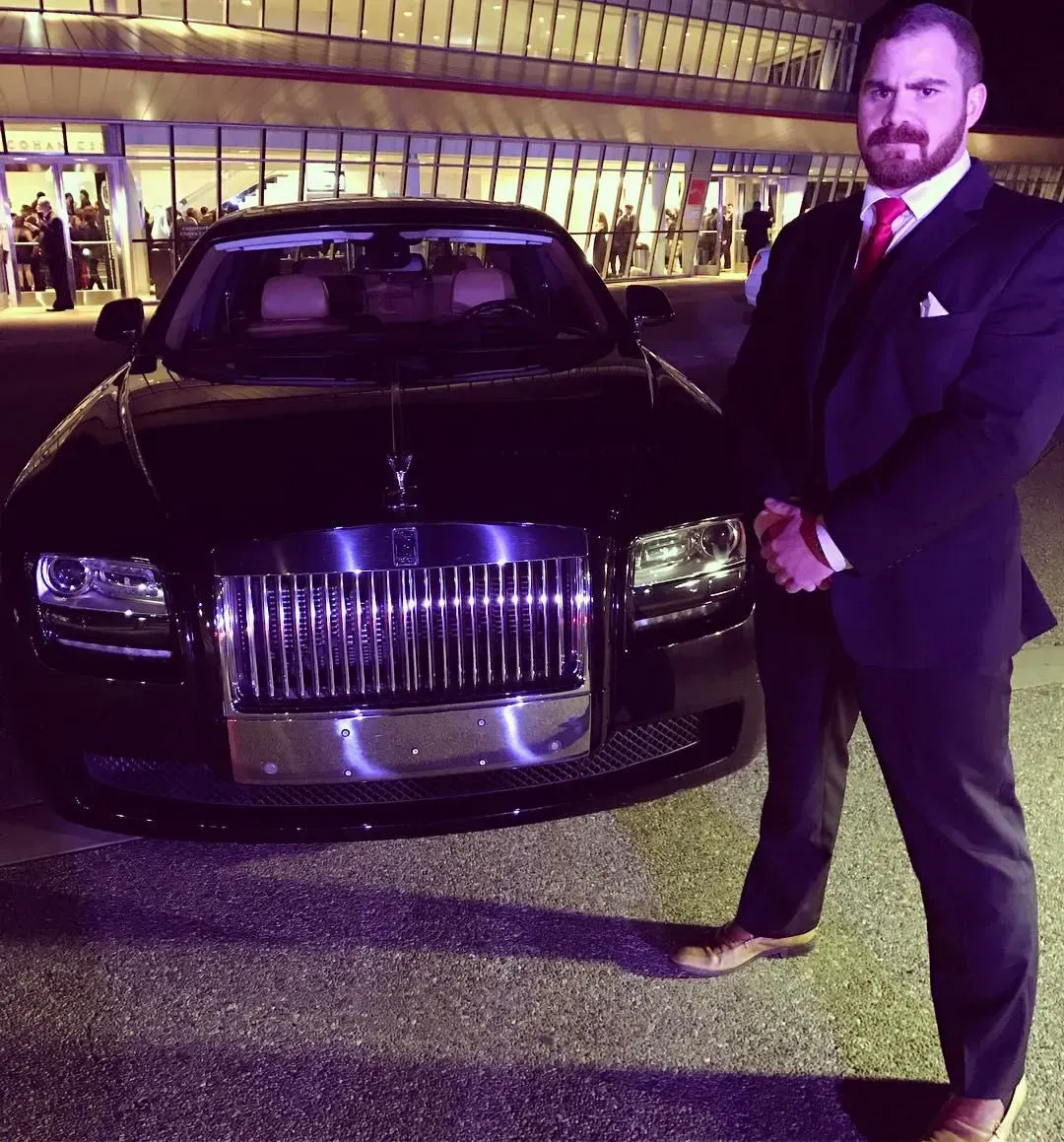 2013 milestone: three advisors celebrating around a glass table with a printed milestone plaque