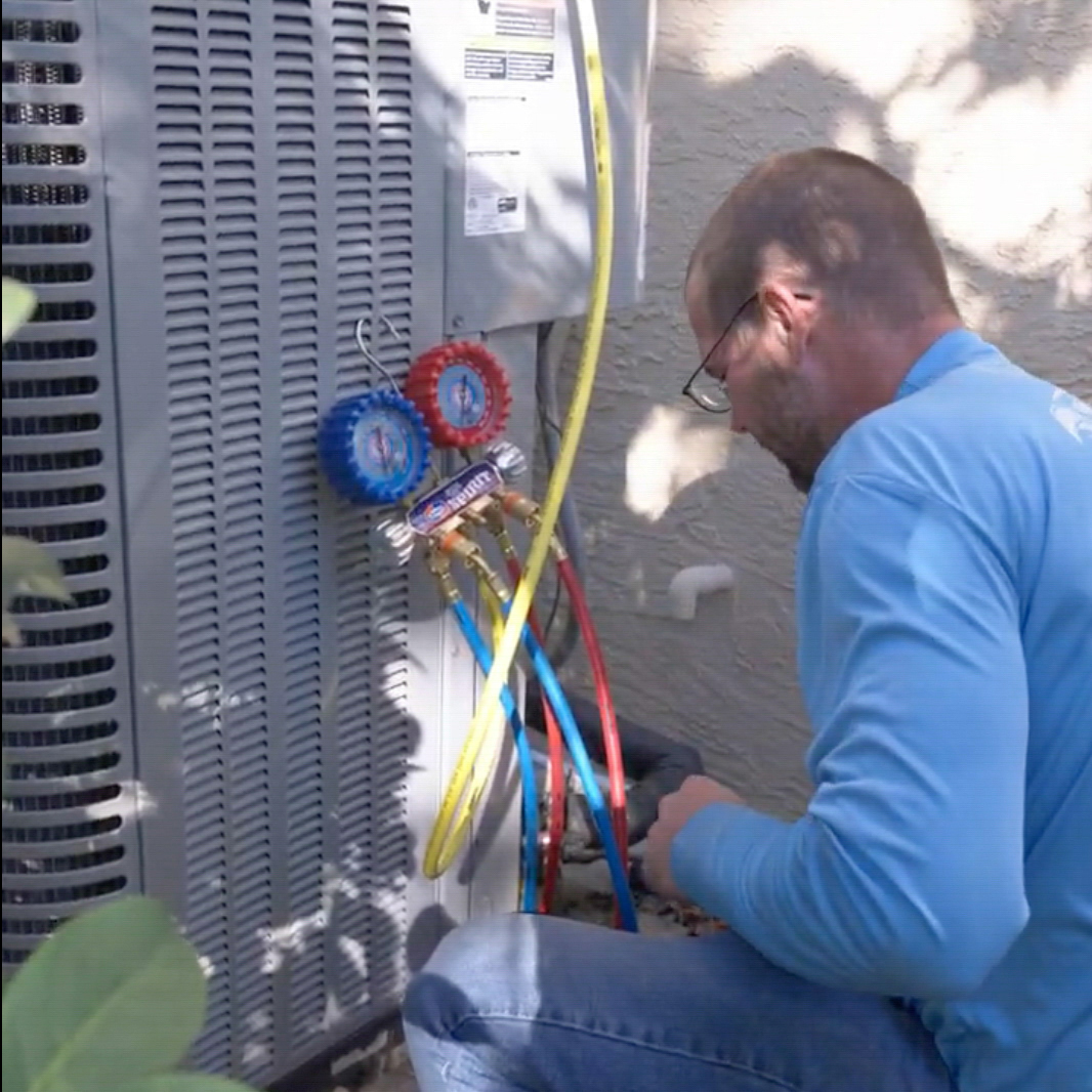 Air conditioning technician servicing AC unit in Safety Harbor