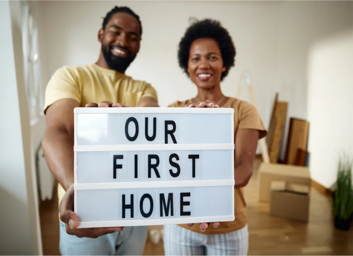 First-time homebuyers in Minnesota reviewing home options with real estate agent in suburban neighborhood