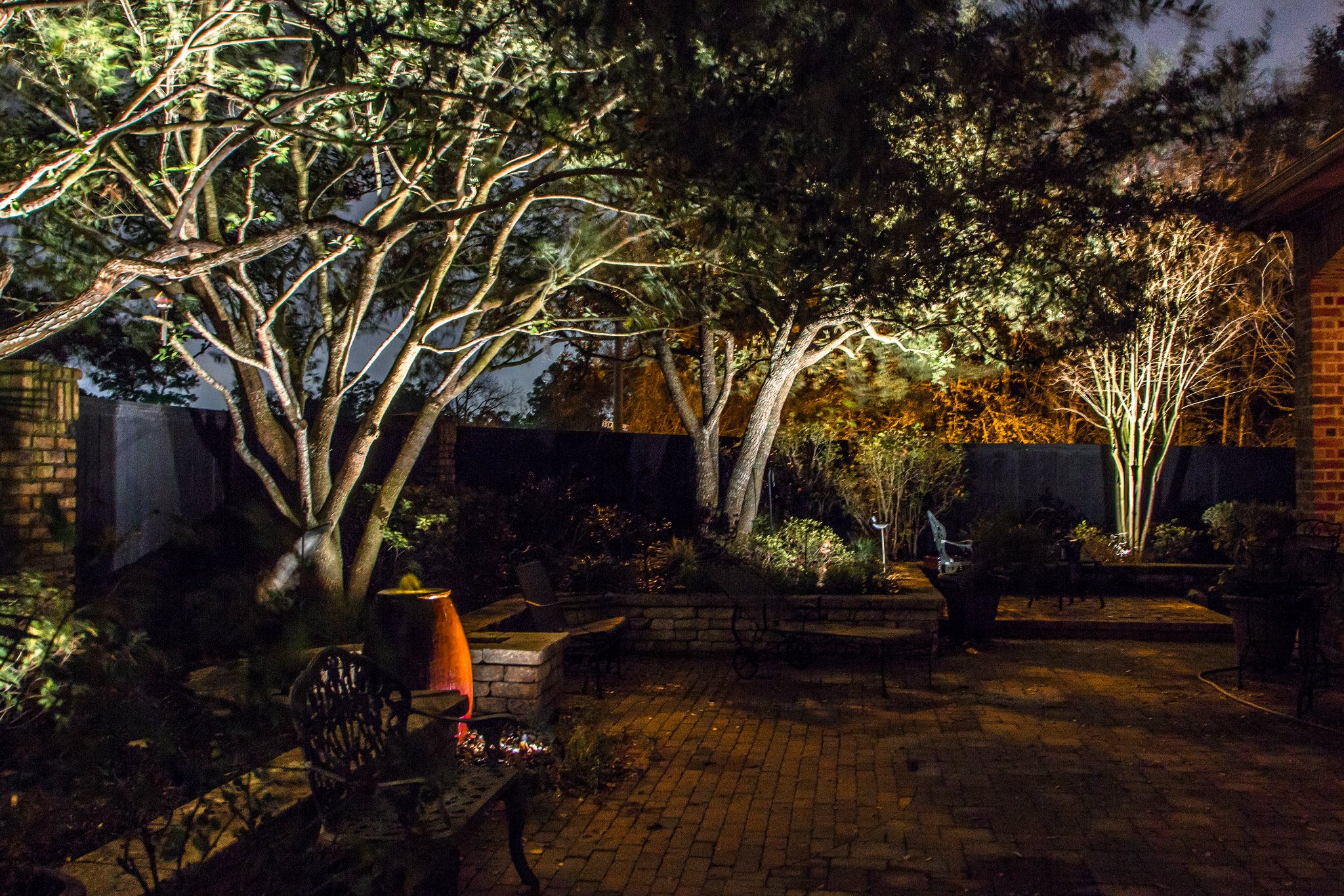 Professional tree trimming and canopy lifting for mature oak trees in a residential Cypress neighborhood.