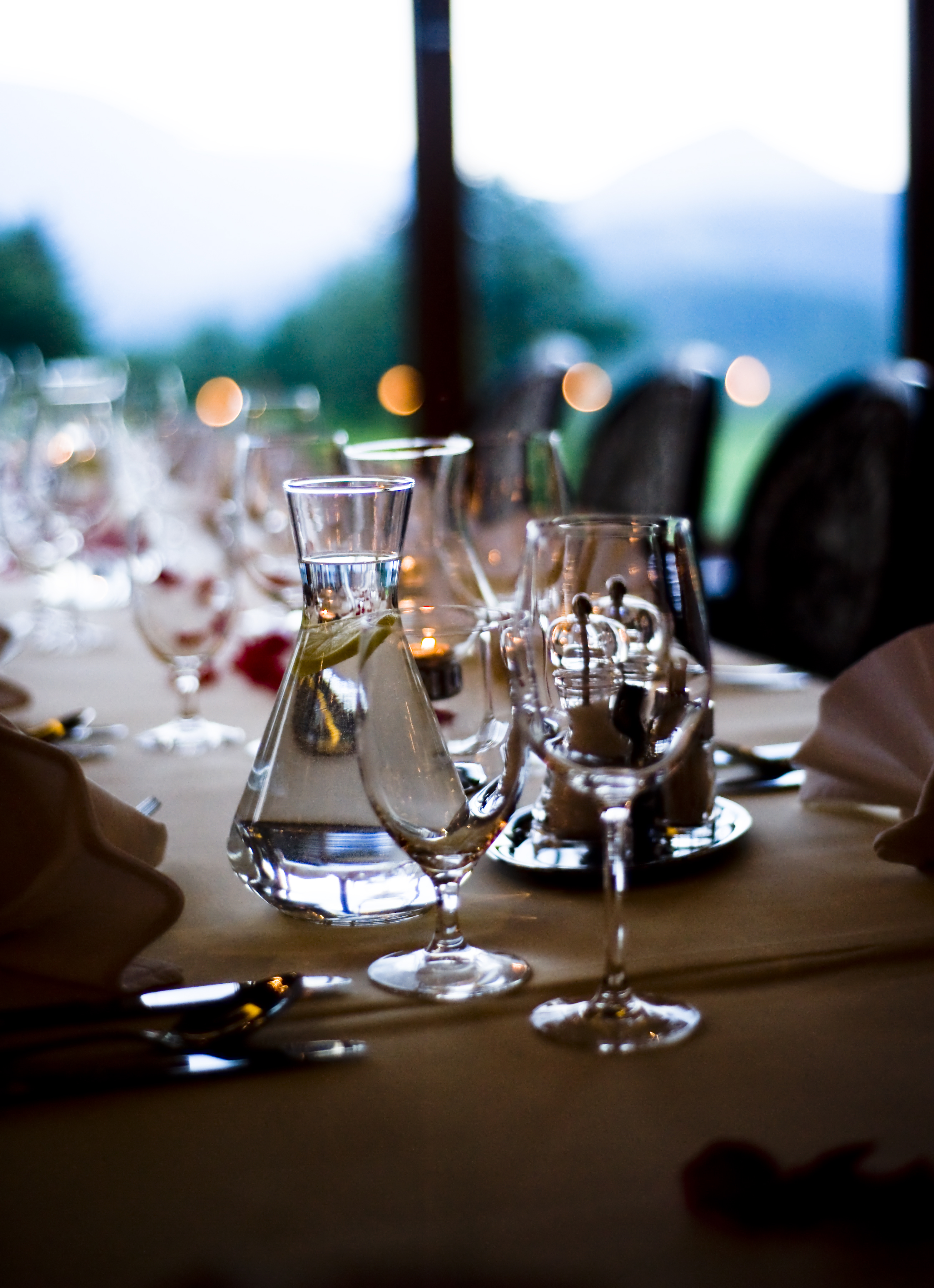 Elegant table setting with candlelight and glassware at a corporate dinner event
