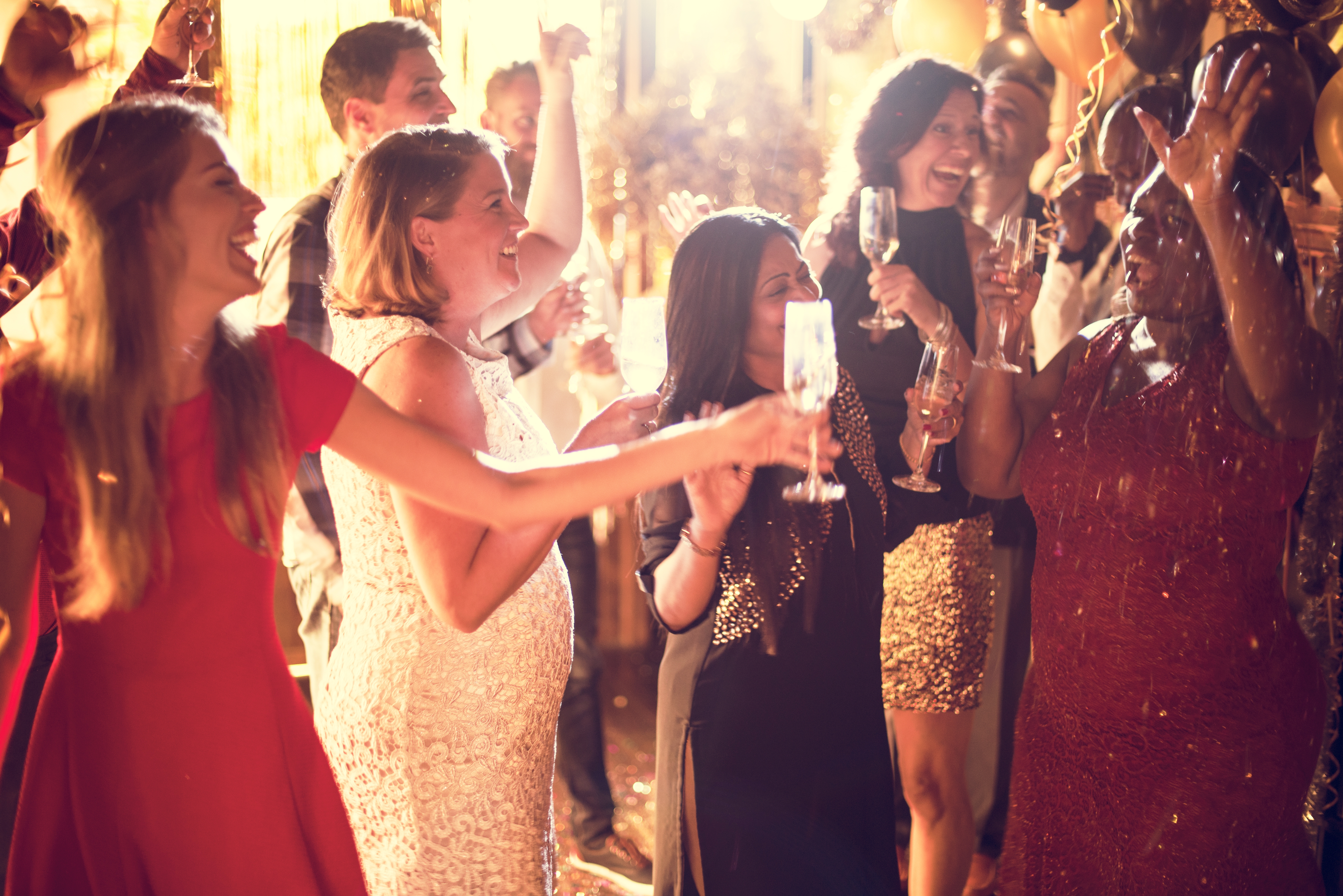 Diverse group of friends toasting at an elegant private celebration event