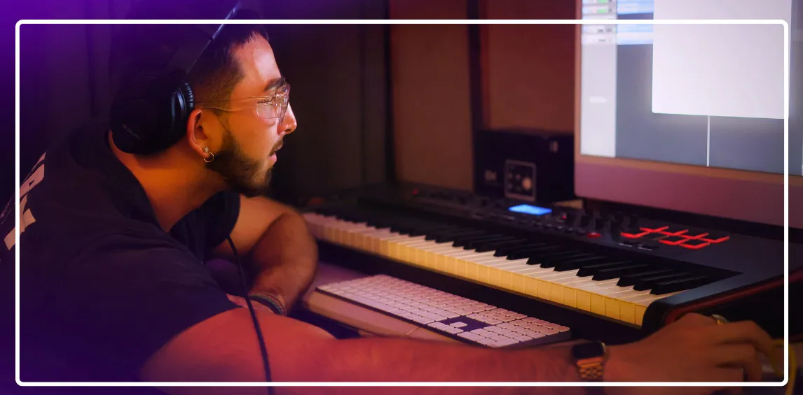 An image of an artist producing music with a keyboard and imac
