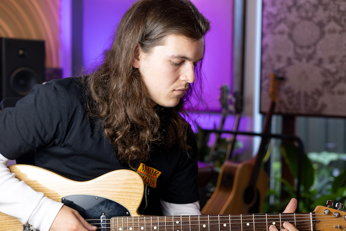 Close up of hands on an acoustic guitar