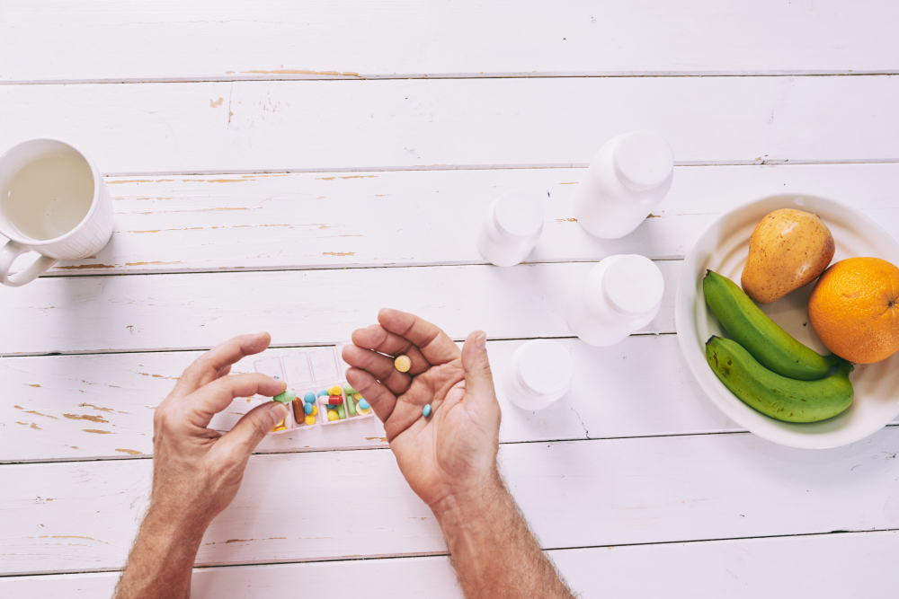 man pouring water in the glass