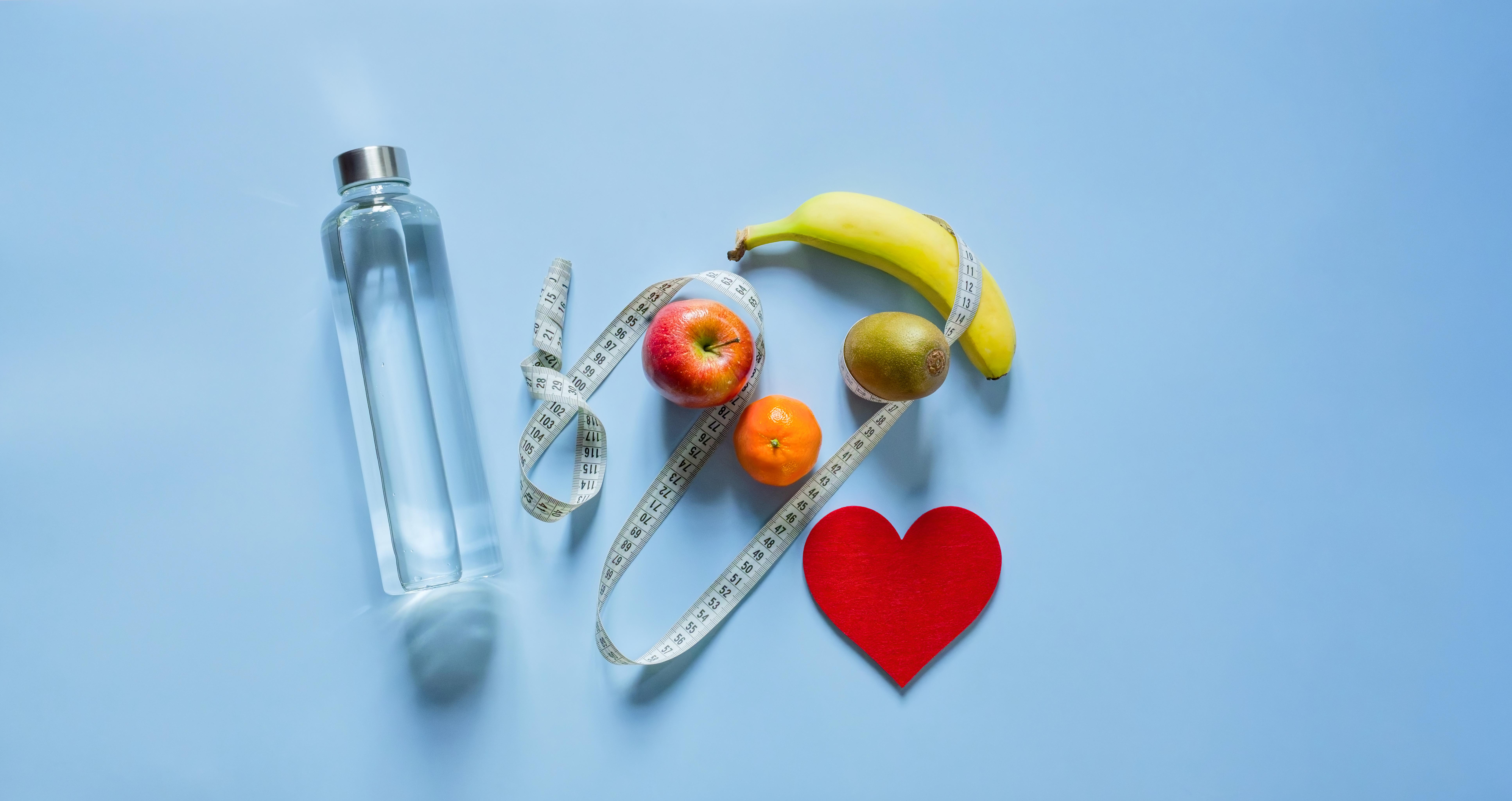 Healthy Habits Flat Lay with Water Bottle, Fresh Fruit, and Heart Icon