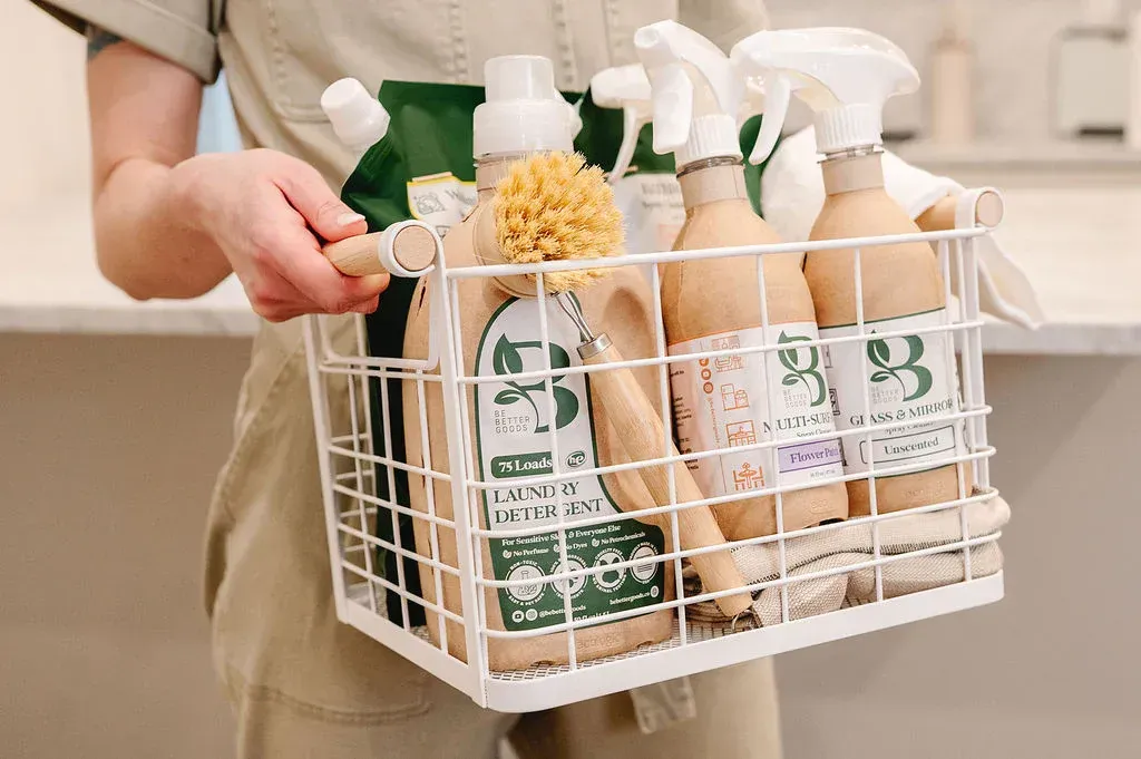 woman carry laundry and cleaning chemicals