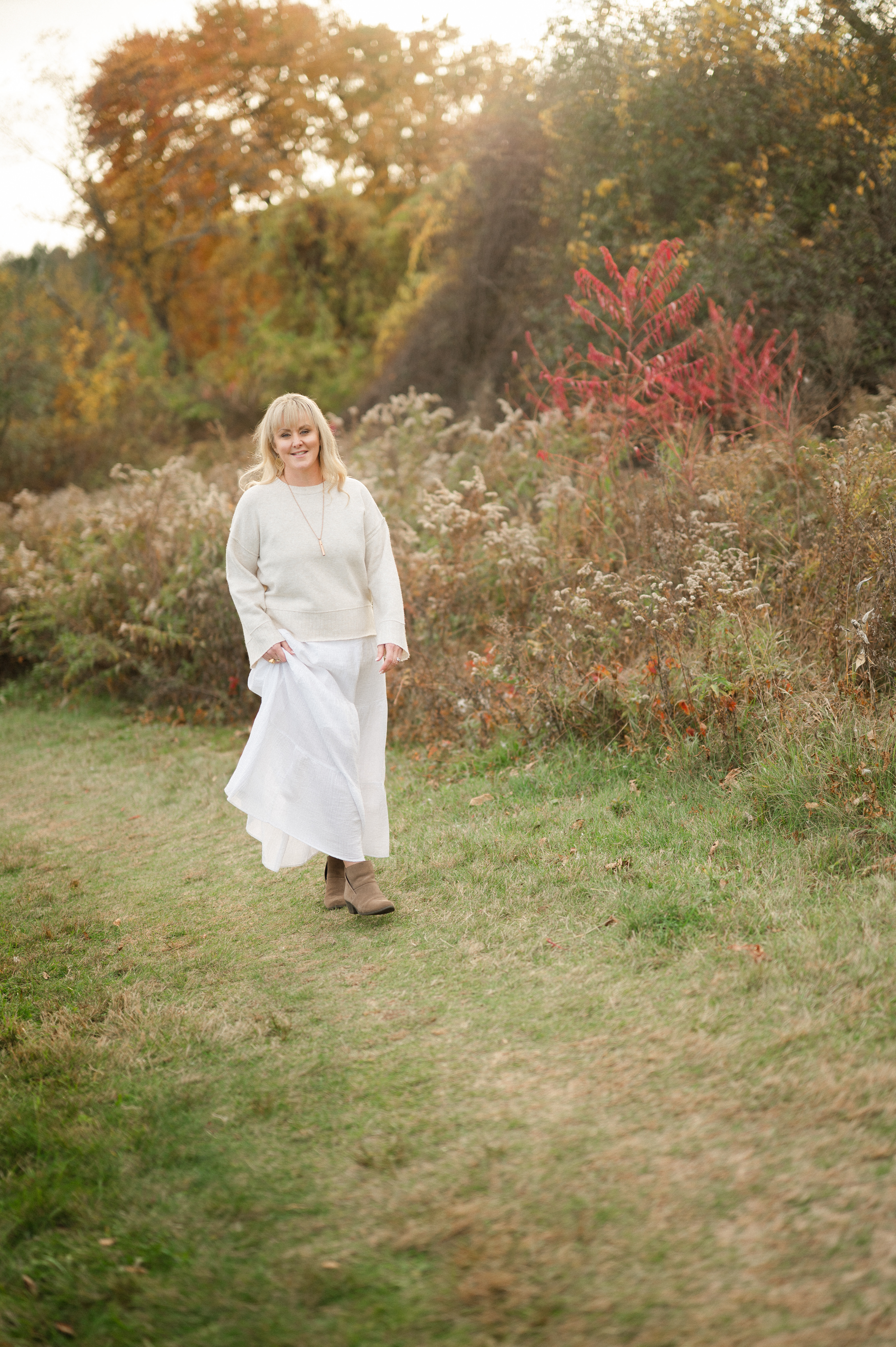 Tall dry grass in the foreground with a lake background.