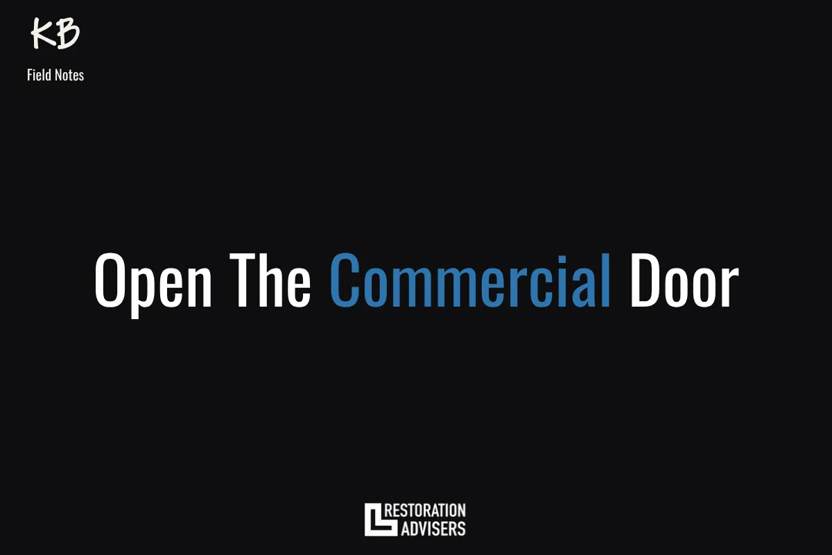 A commercial building exterior with large industrial doors, overlaid with bold text reading "Walk Through The Door — Why Restorers Shy Away From Commercial Restoration."