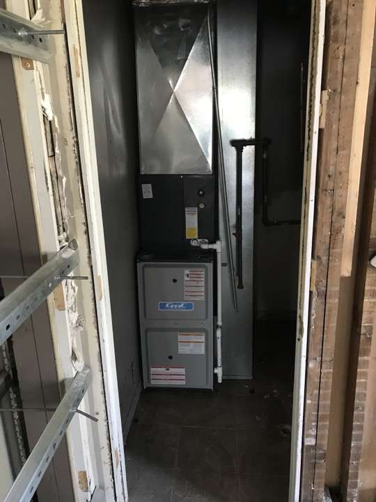New furnace installed in a framed closet with supply and return ductwork