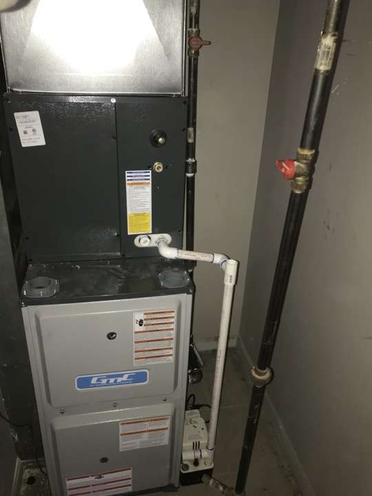 Furnace installation with PVC exhaust venting in a residential basement