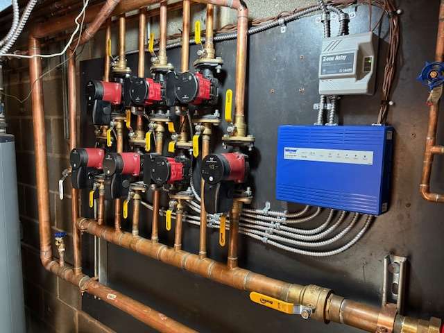 Hydronic zone manifold with circulation pumps and zone controller installed in a Chicago home