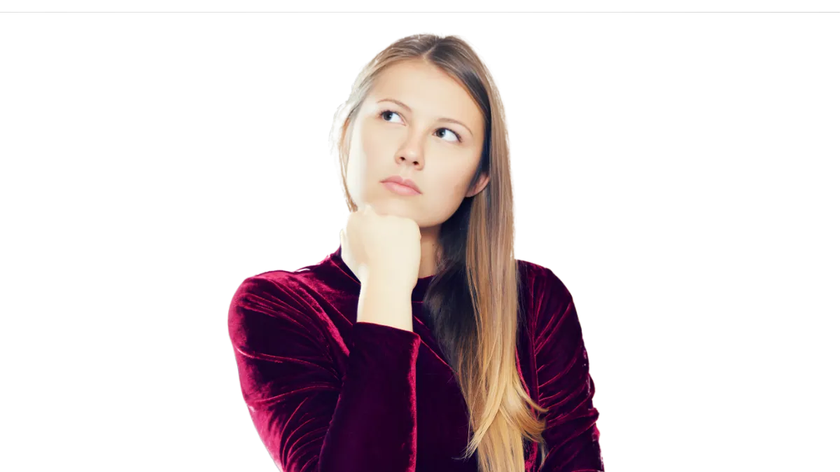 A woman in a velvet dress looking up thoughtfully, symbolizing a business owner contemplating new strategies or solutions.