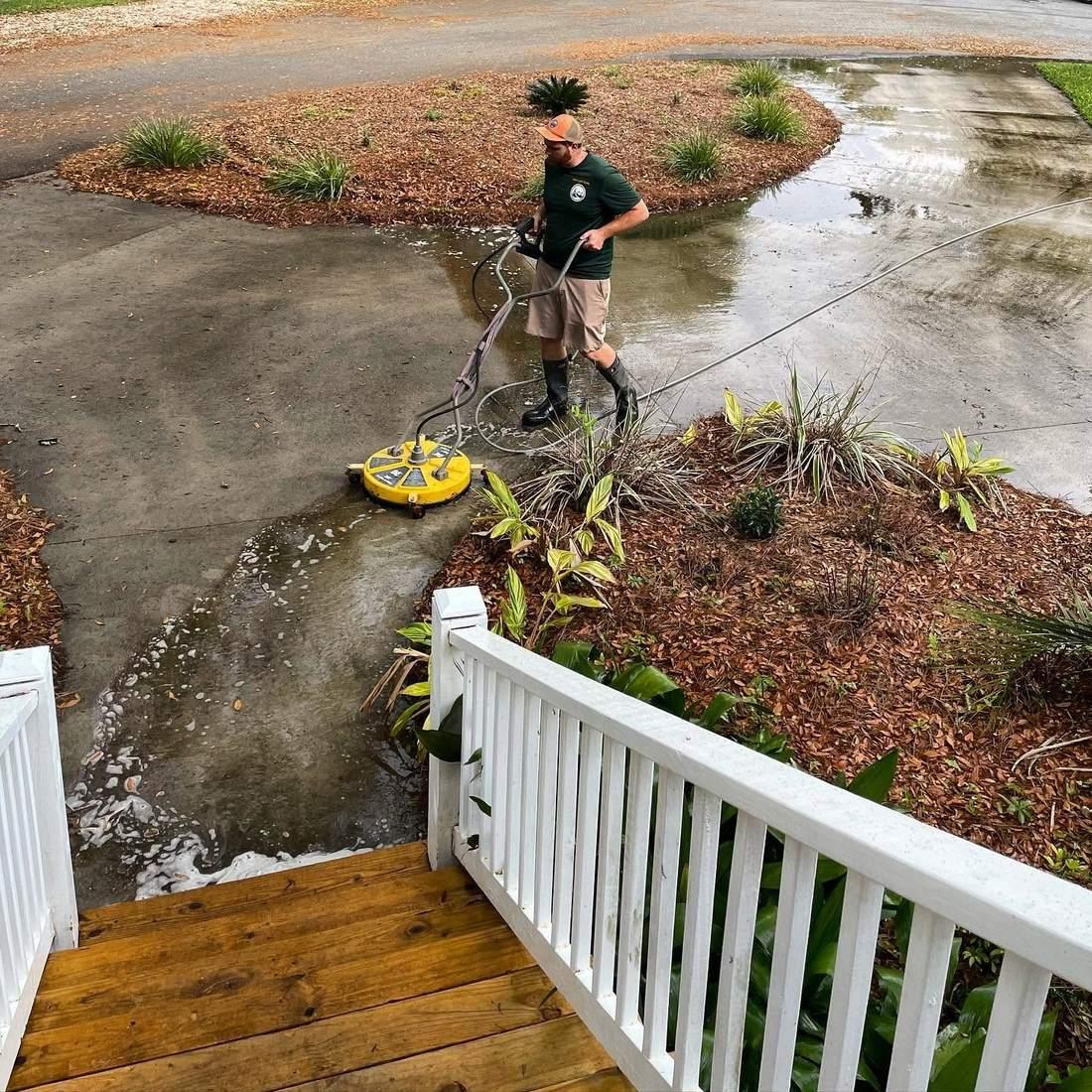 Concrete driveway half pressure washed, showing the algae removed, Brunswick GA