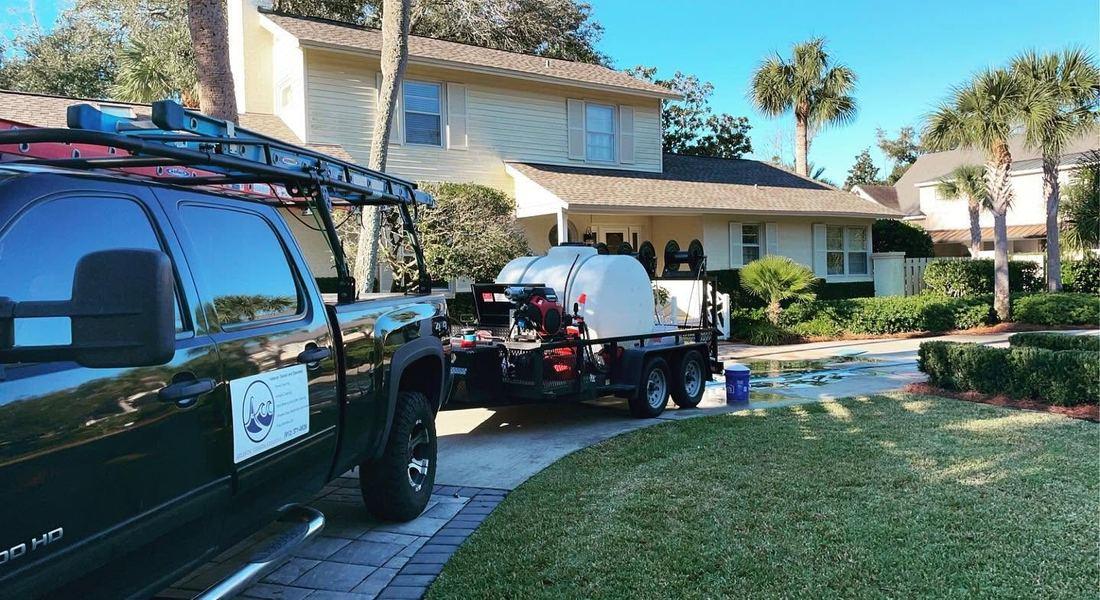 Atlantic Coastal Cleaning truck and water tank outside a Sea Island, GA home