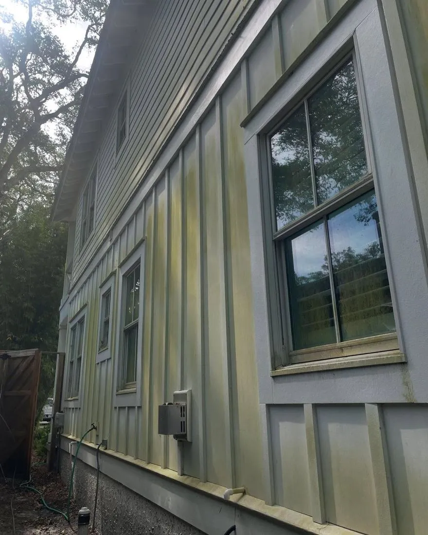 Mildew stained board and batten siding on a St. Simons Island home before soft washing