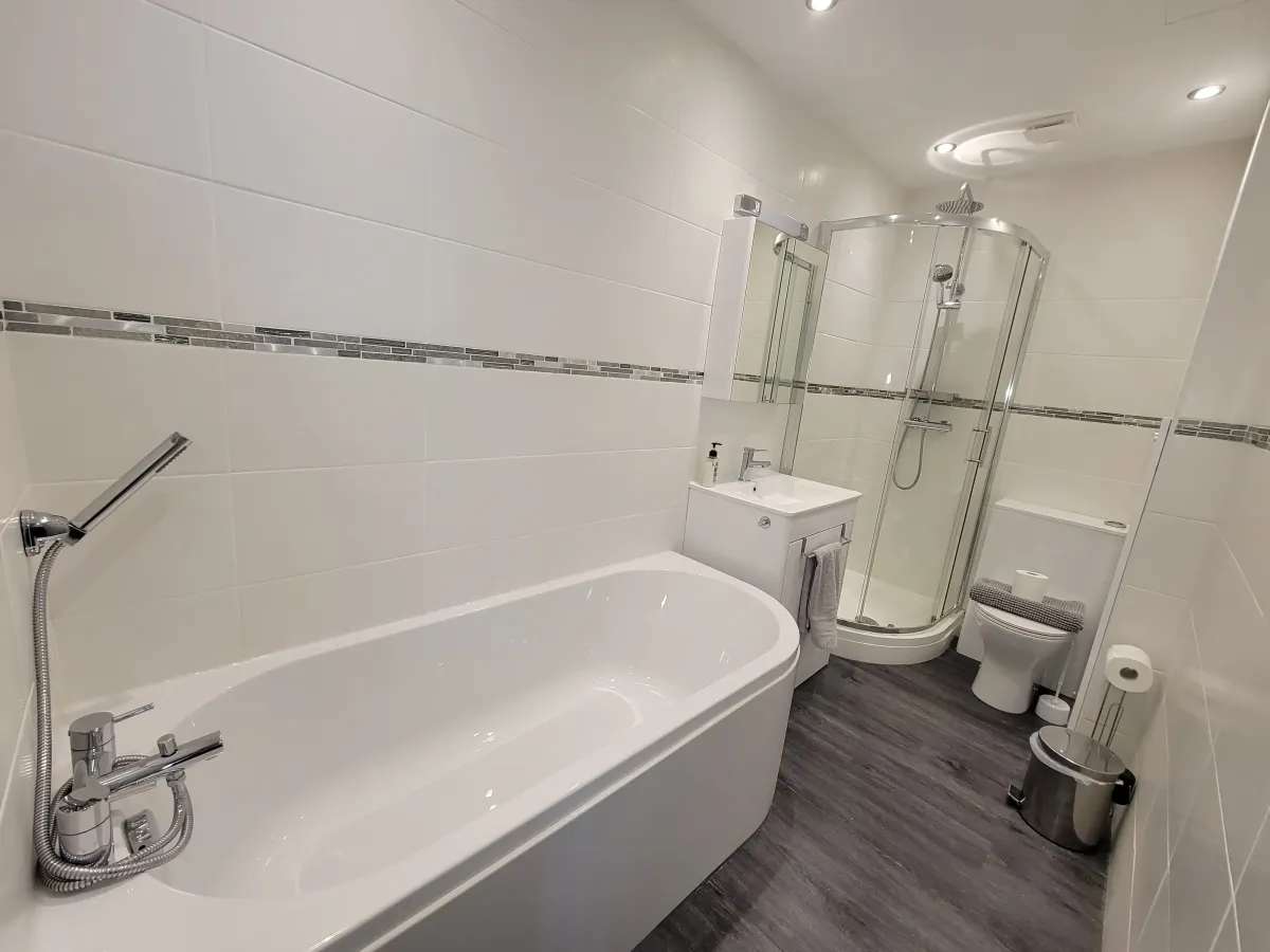 En-suite bathroom with large deep bath and separate shower