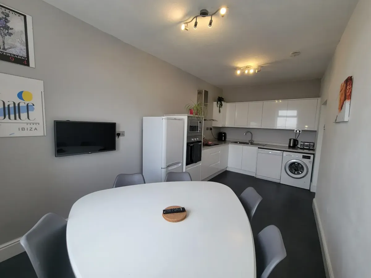 Kitchen with a washing machine, fridge freezer, induction hob, oven, microwave, air fryer, kettle and toaster