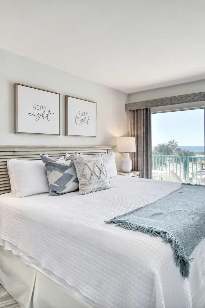 woman setting sheets on bed