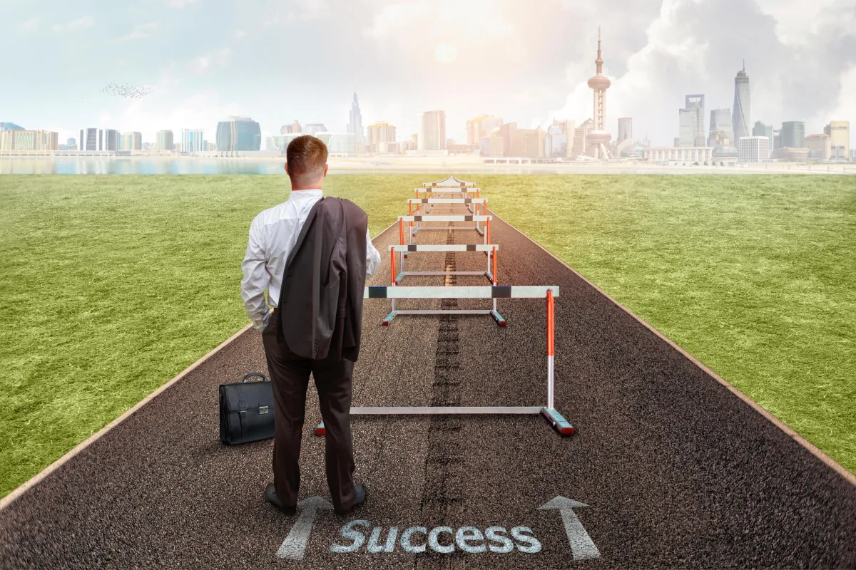 man sitting on rock surrounded by water