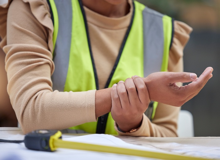 Guy at construction site with arm pain