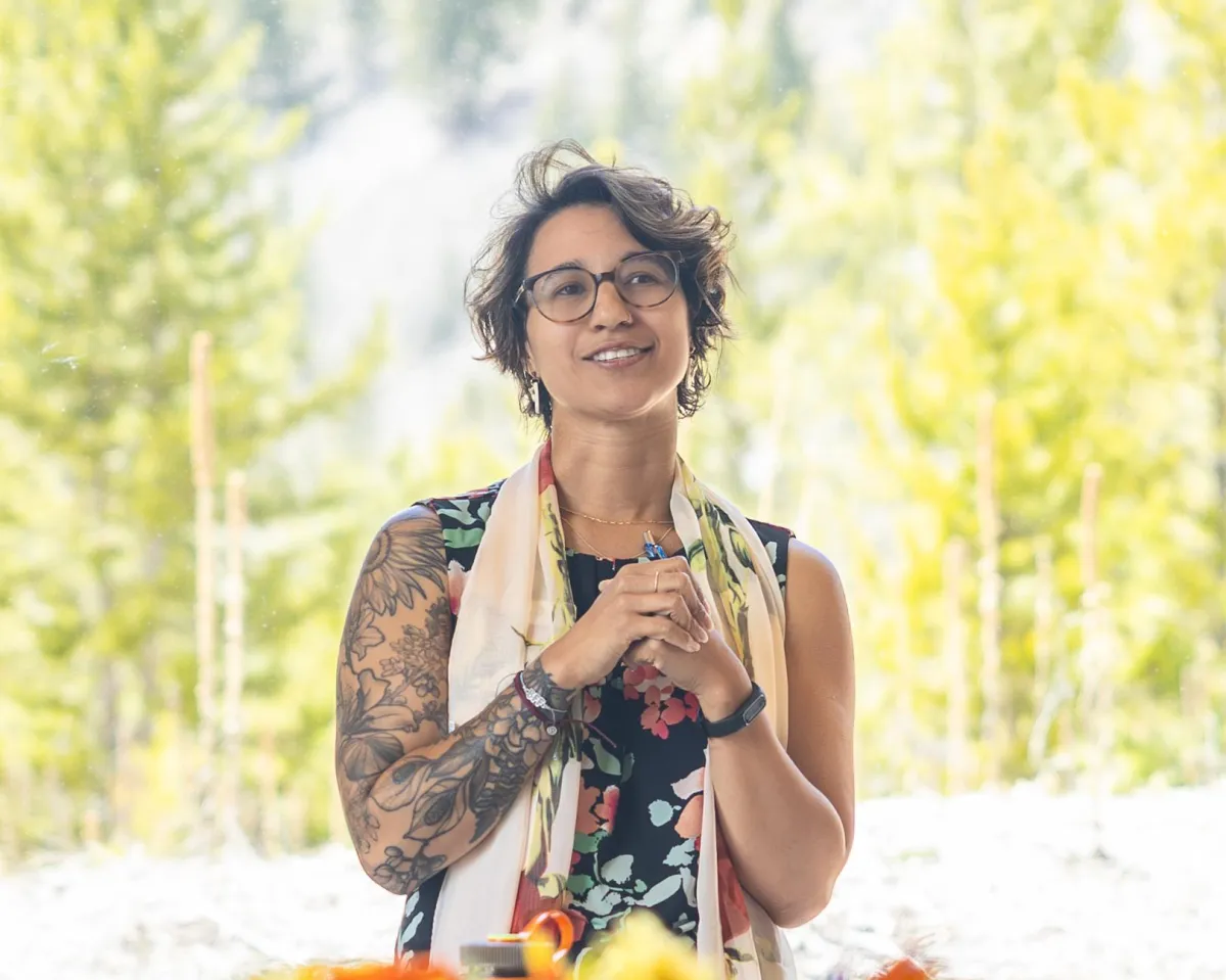Participant smiling during Whole YOU Retreat group session, captured in natural light
