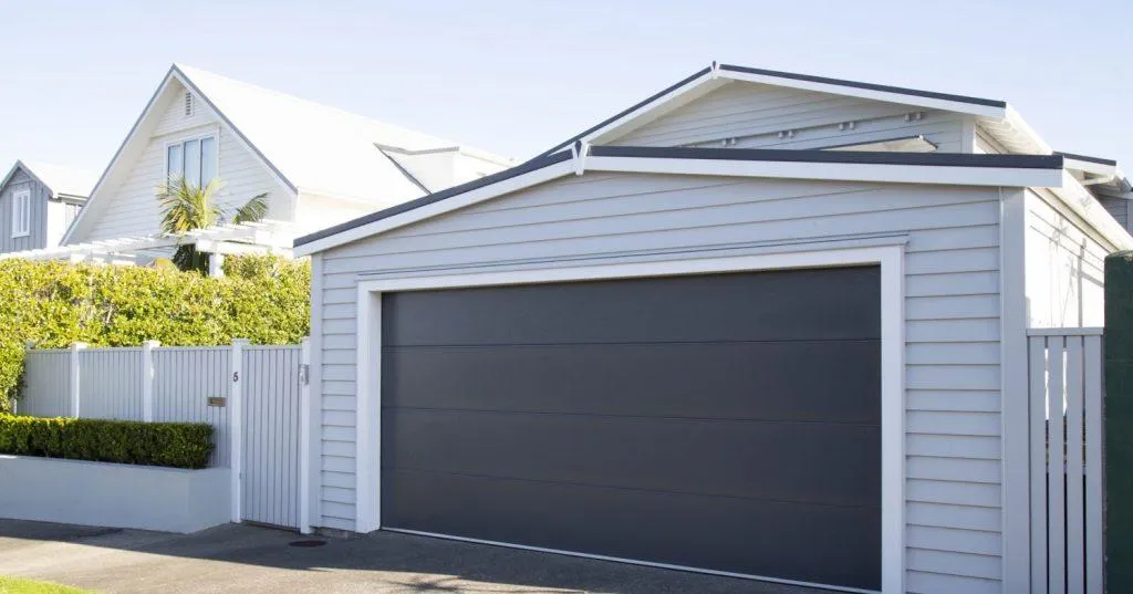 a black and white house with two black doors