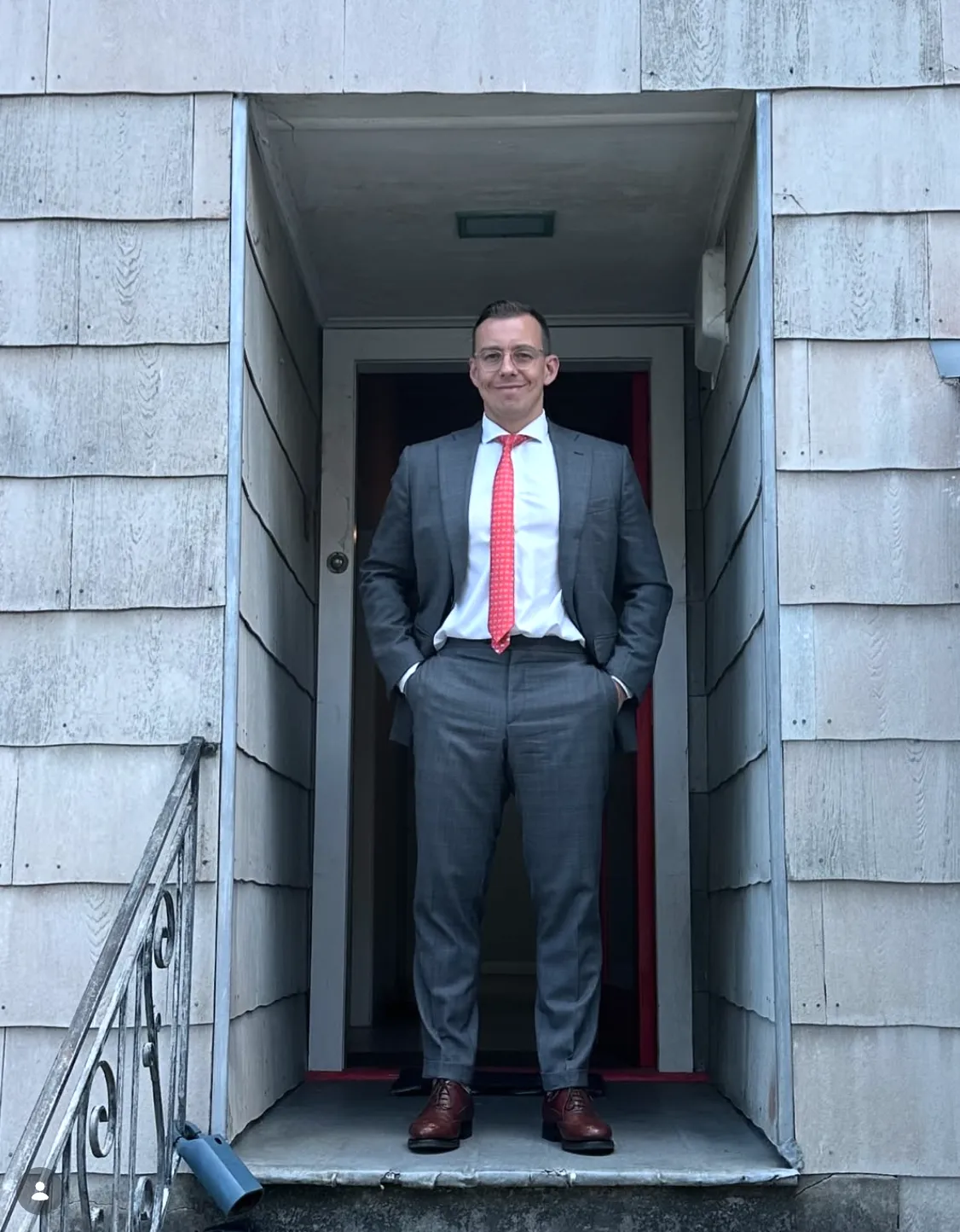 a silver car parked in front of some trees