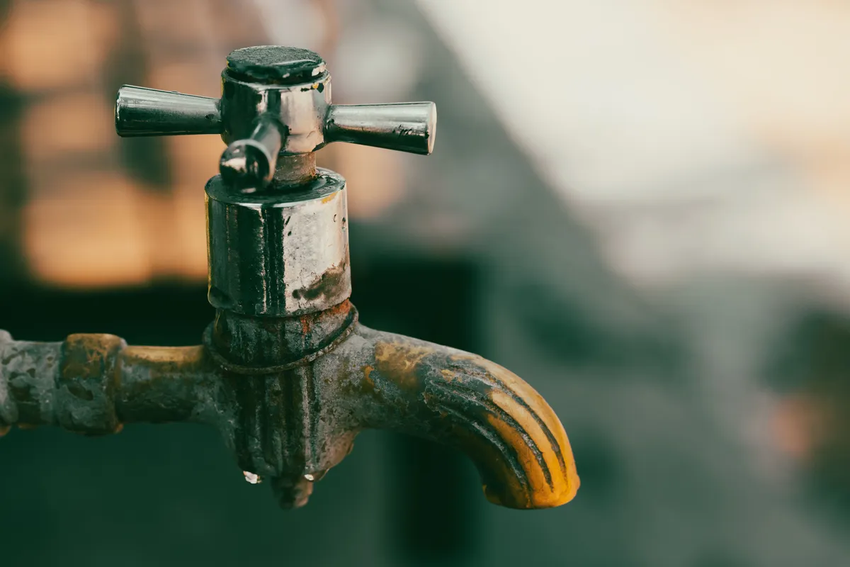 White mineral scale buildup on a faucet fixture