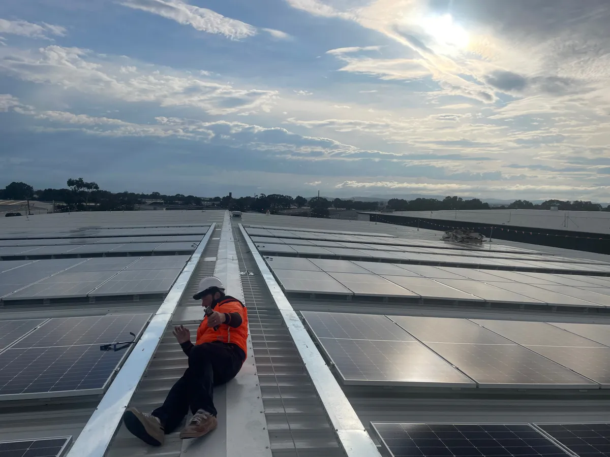Pat Southwell, Licensed Electrical Inspector, inspecting a large commercial rooftop solar array